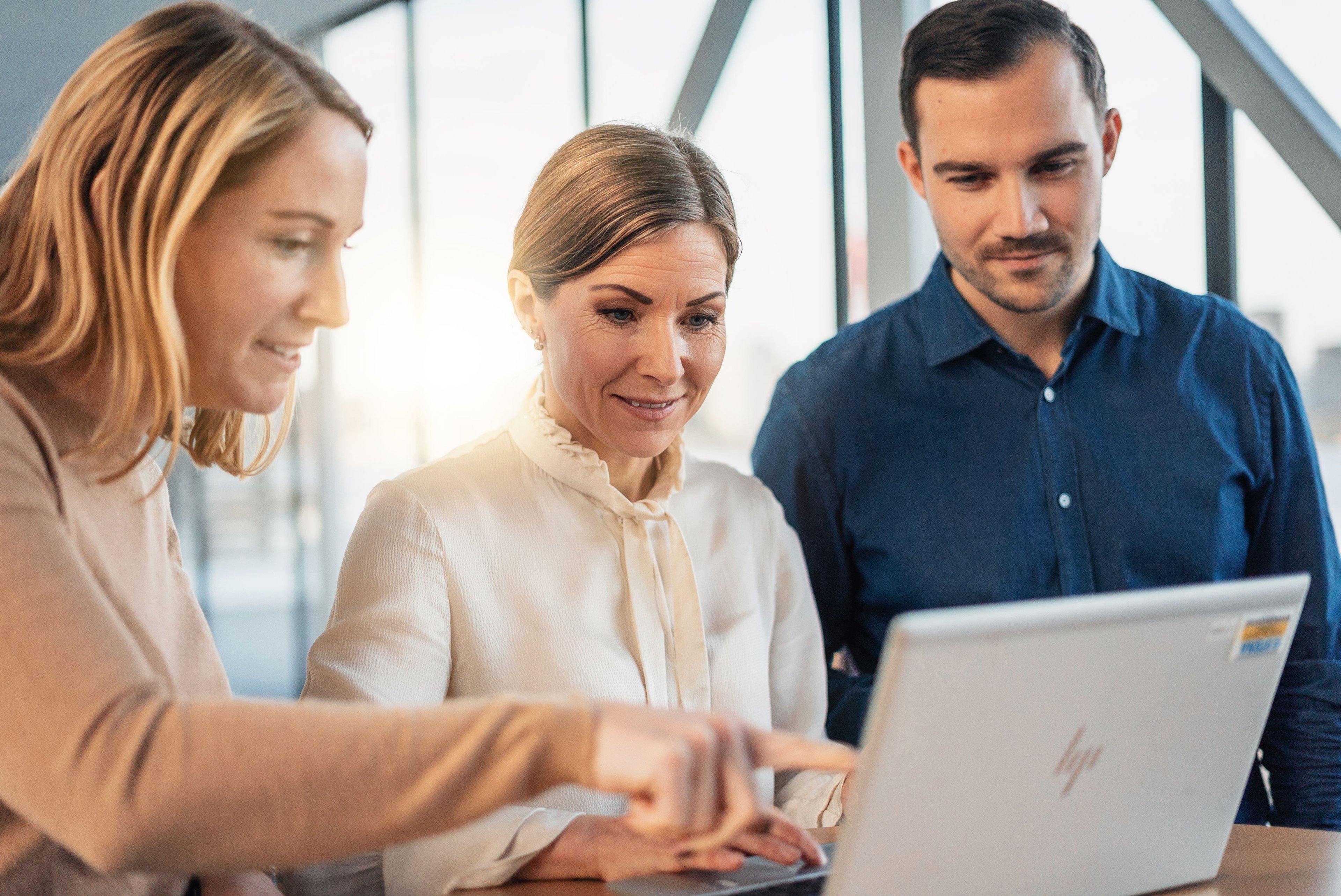 A Stena Metall Group employee goes through an environmental report with two Stena Metall Group customers.