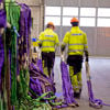 Two Stena Metall Group employees in hi-vis protective gear check equipment in a Stena facility.