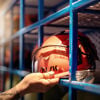 The hand of a Stena Metall Group employee reaches for their protective hard hat.