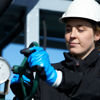 A female Stena Oil employee helps to take care of an oi spill at sea.