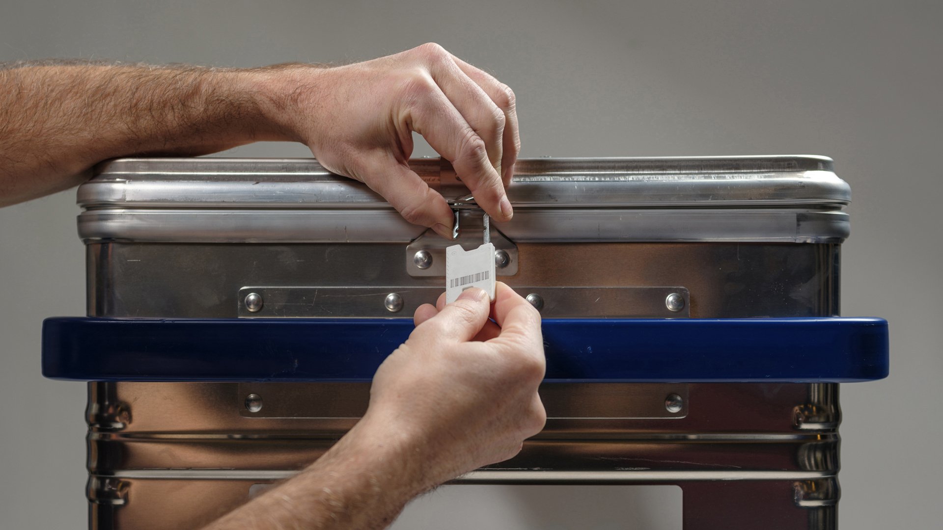 Metal container for confidential documents are securely locked by an employee of Stena Confidential