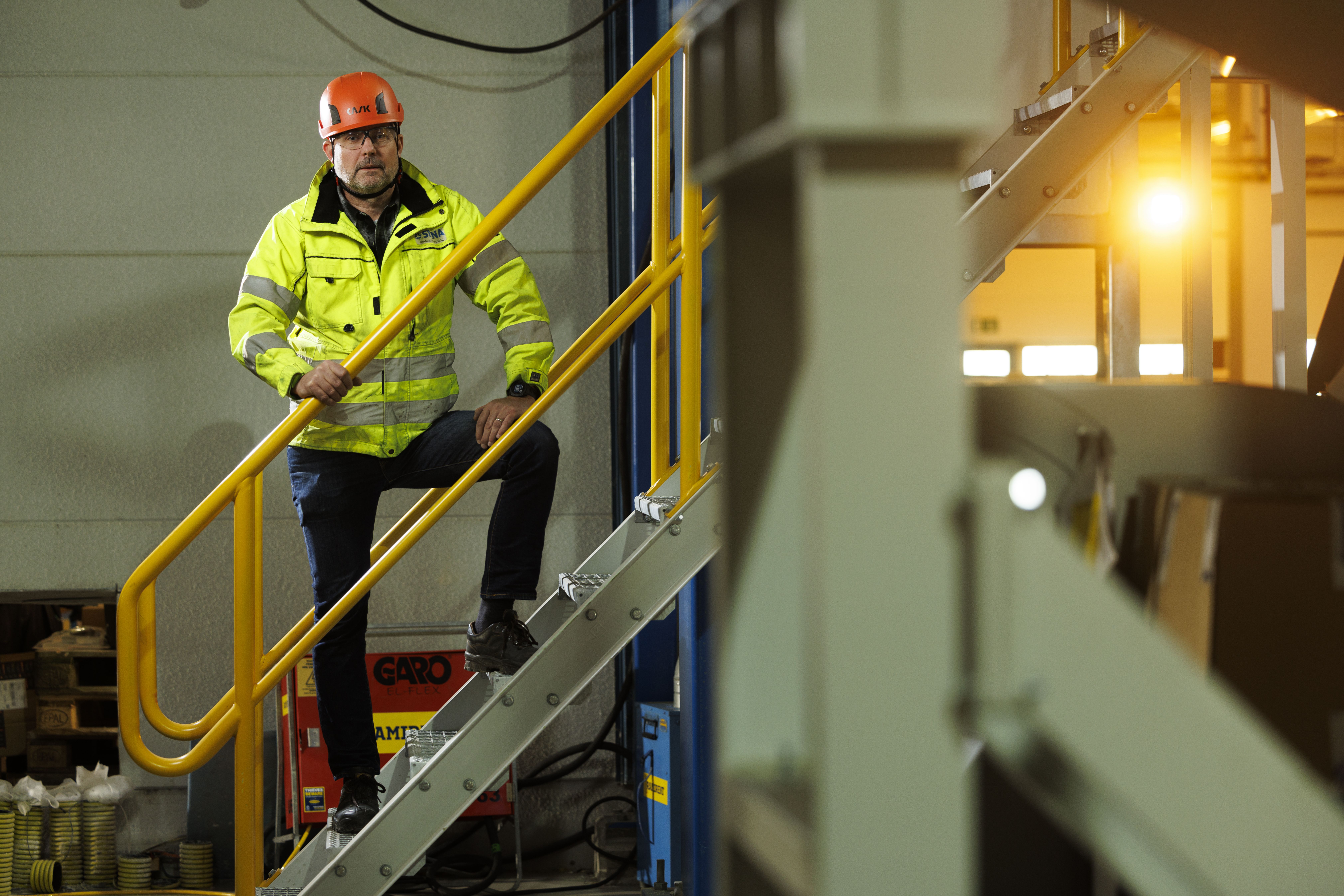 Nils Jonasson wearing his protective gear and standing on a starcase