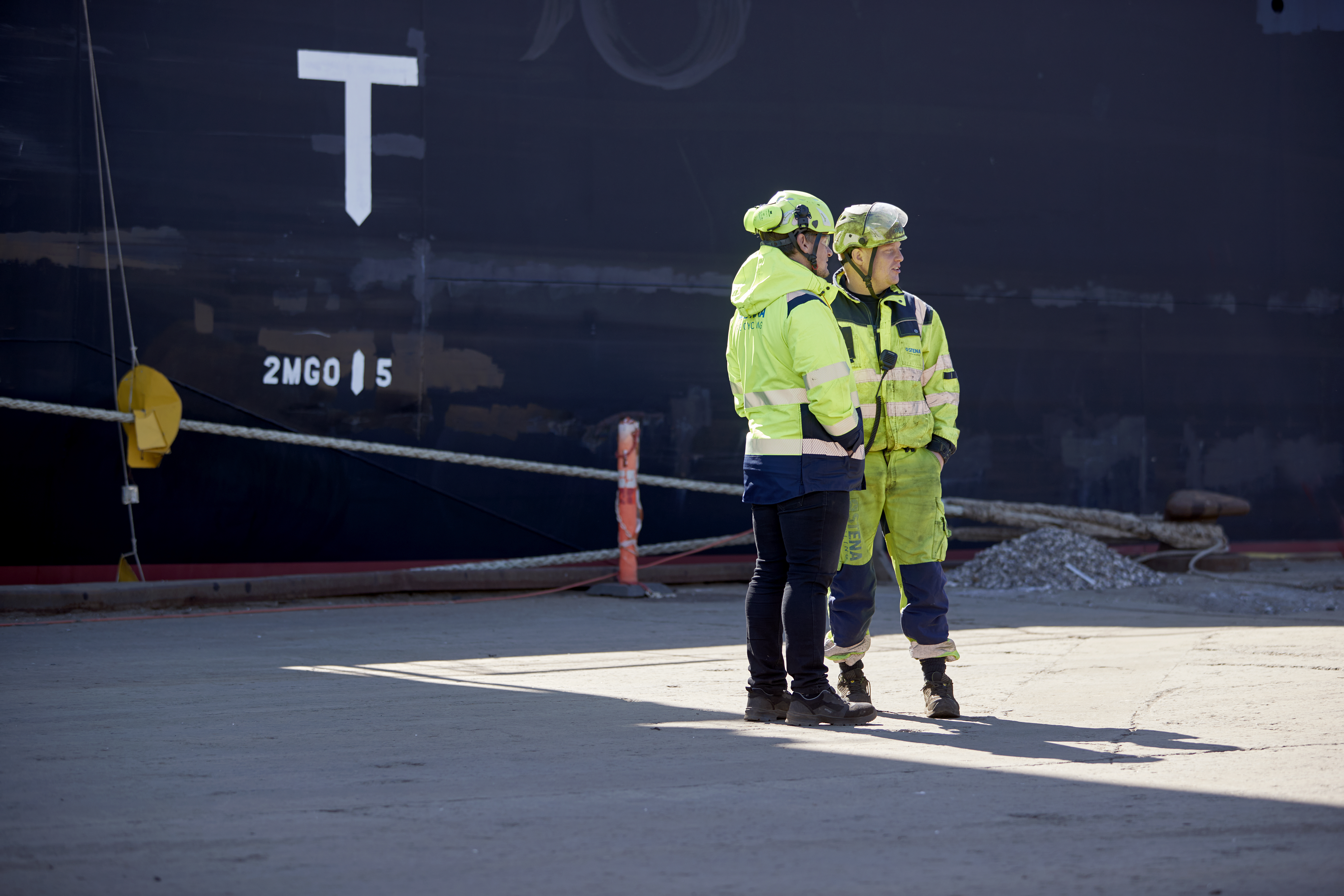 two people standing at a recycling facility