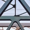 A close-up image of the girders of a  bridge.