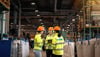 A group of three Stena Metall Group employees talk at Stena Nordic Recycling Center, Halmstad, Sweden.