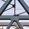A close-up image of the girders of a  bridge.