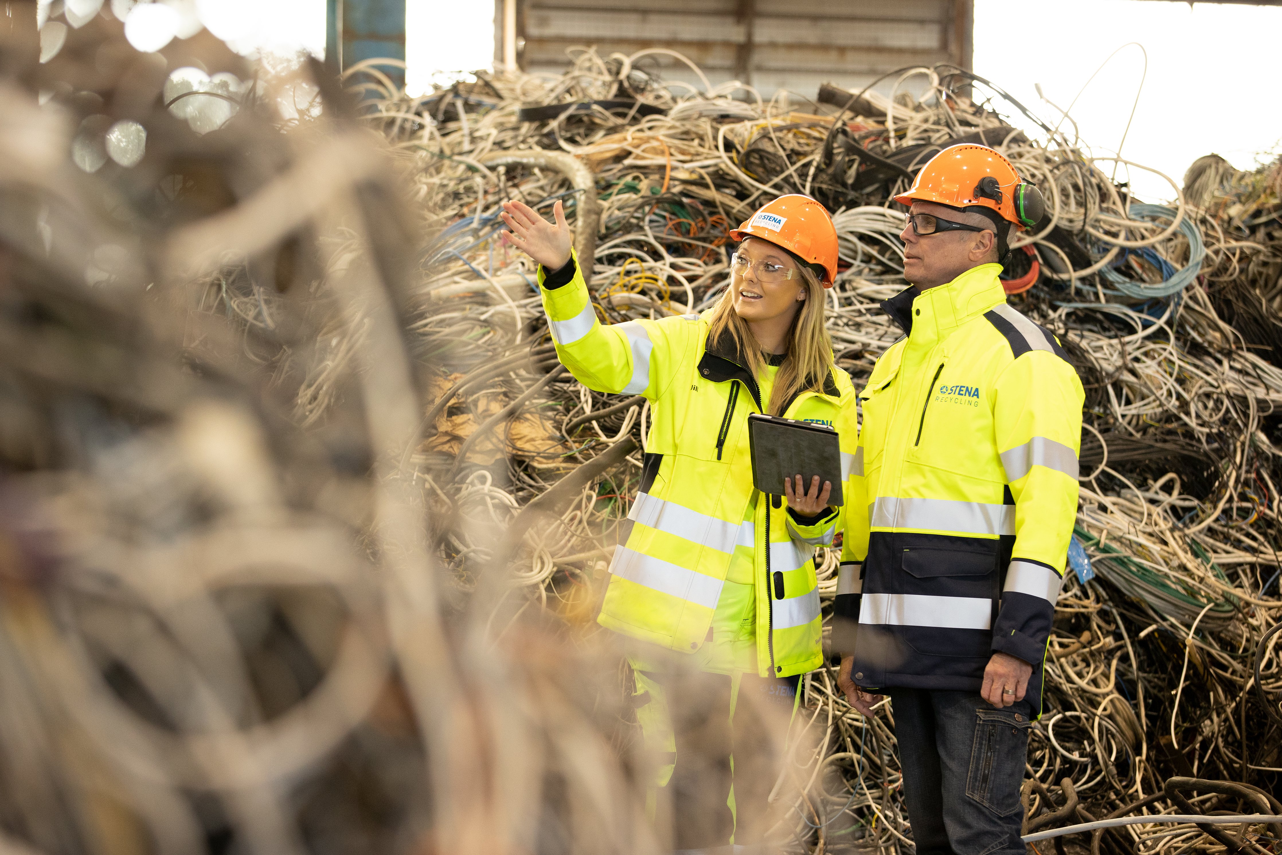 Two Stena Recycling employees discussing the production