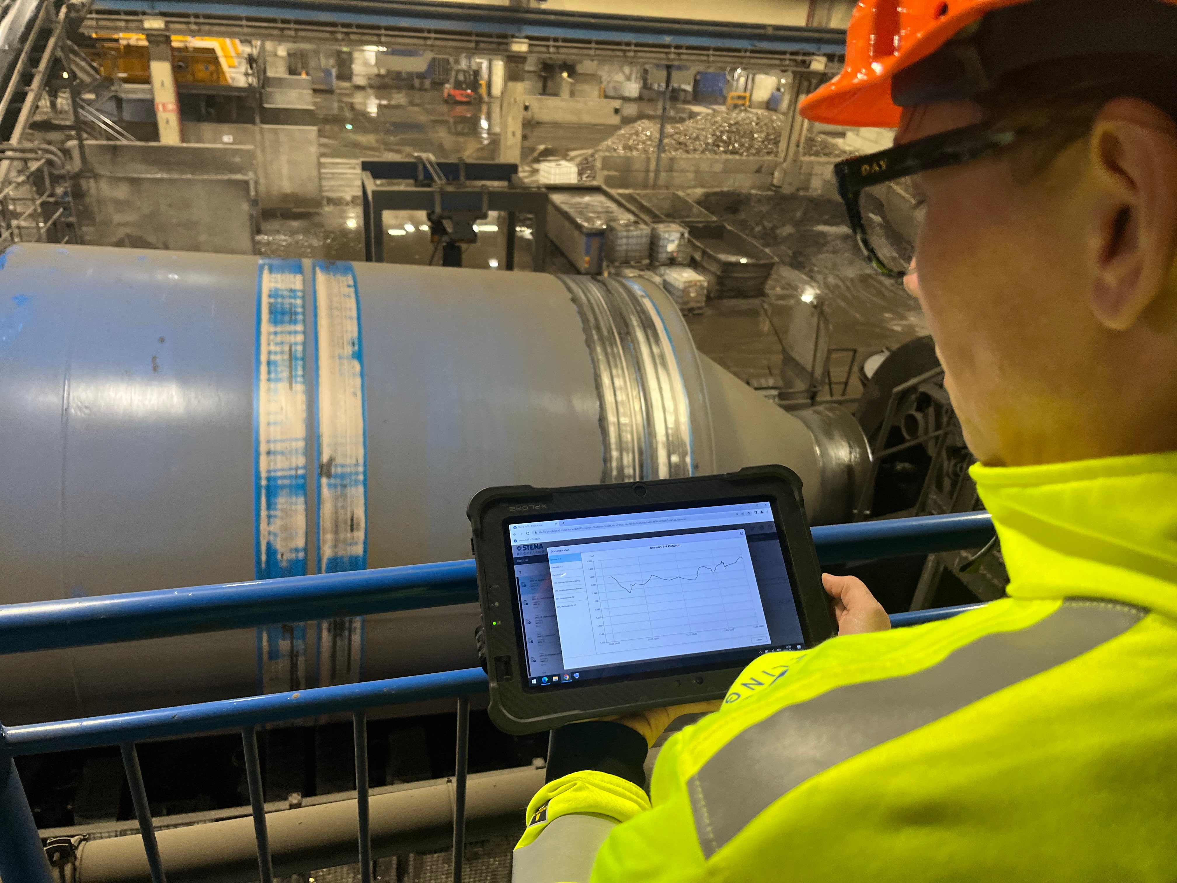 Åsa Fast Berglund at Stena Metall's research and development department collects and analyzes data by a shredder at a fragmentation facility, as part of an Industry 4.0 initiative.